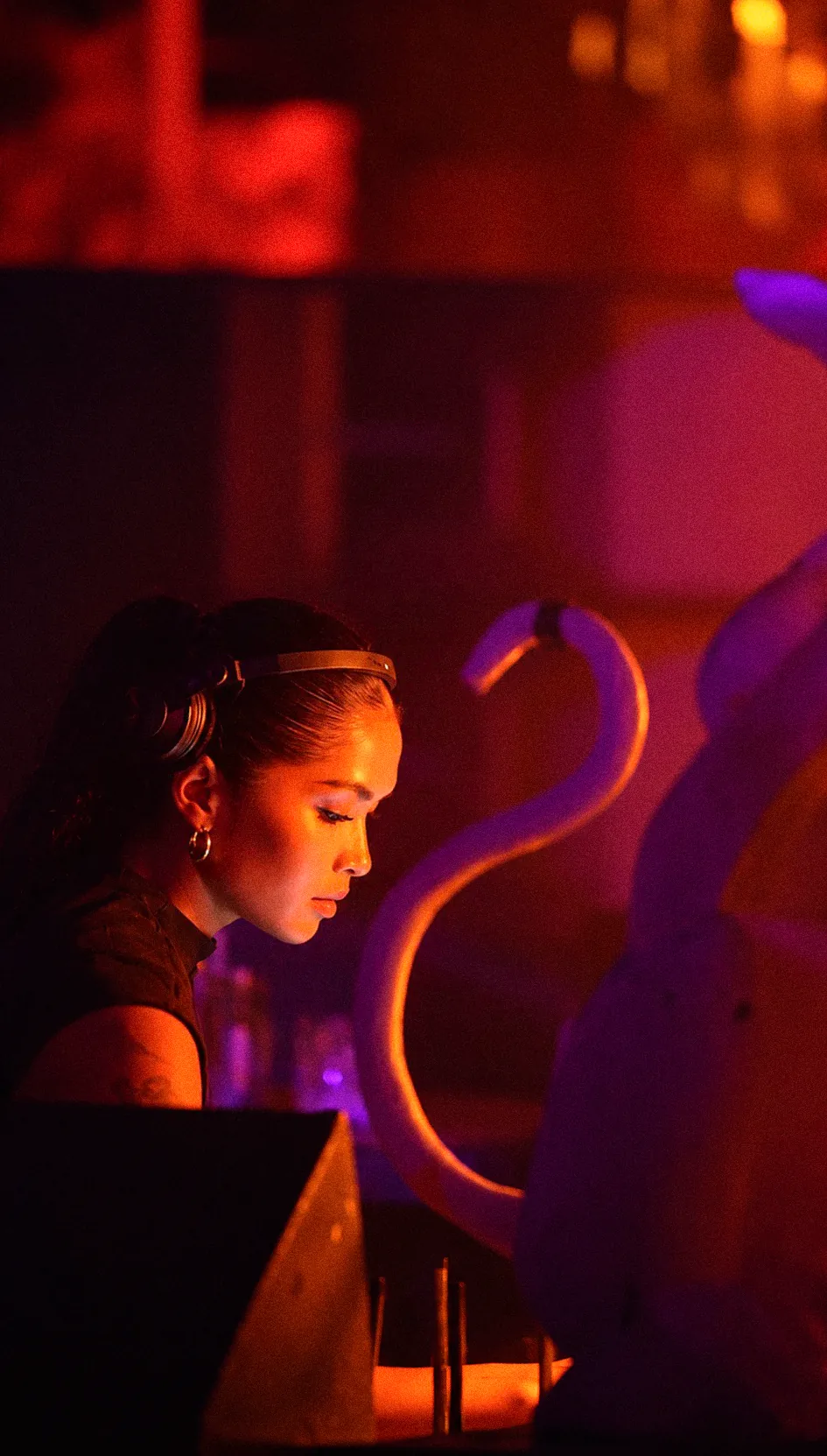 Amias DJing under red and purple light