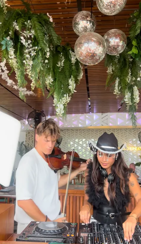 Amias DJing with a live violinist